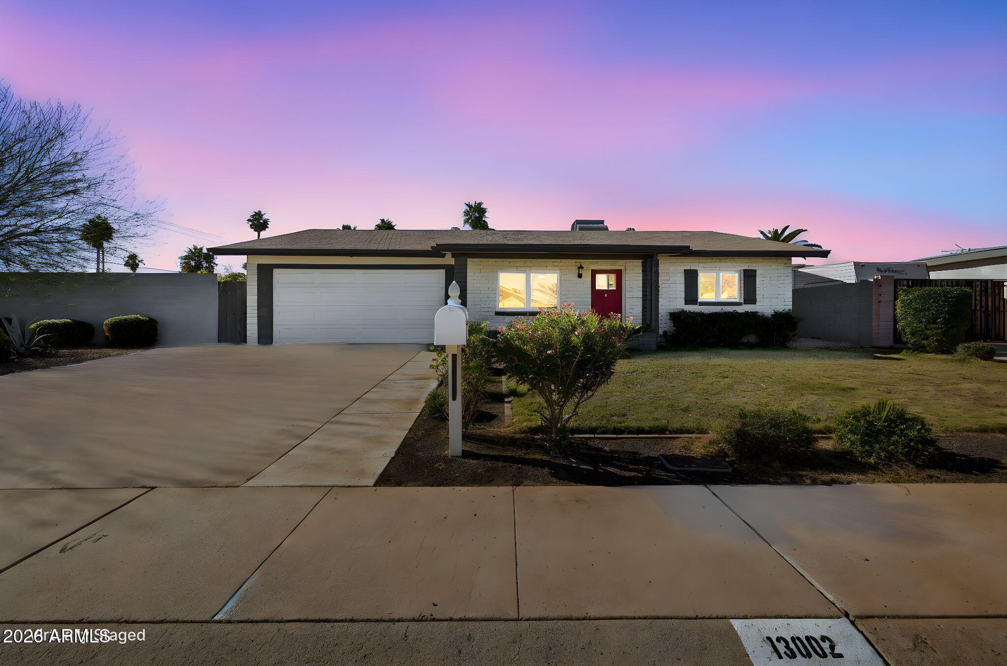 13002 North 28th Place Phoenix, AZ 85032 - Photo 2 of 42 a front view of a house with a yard