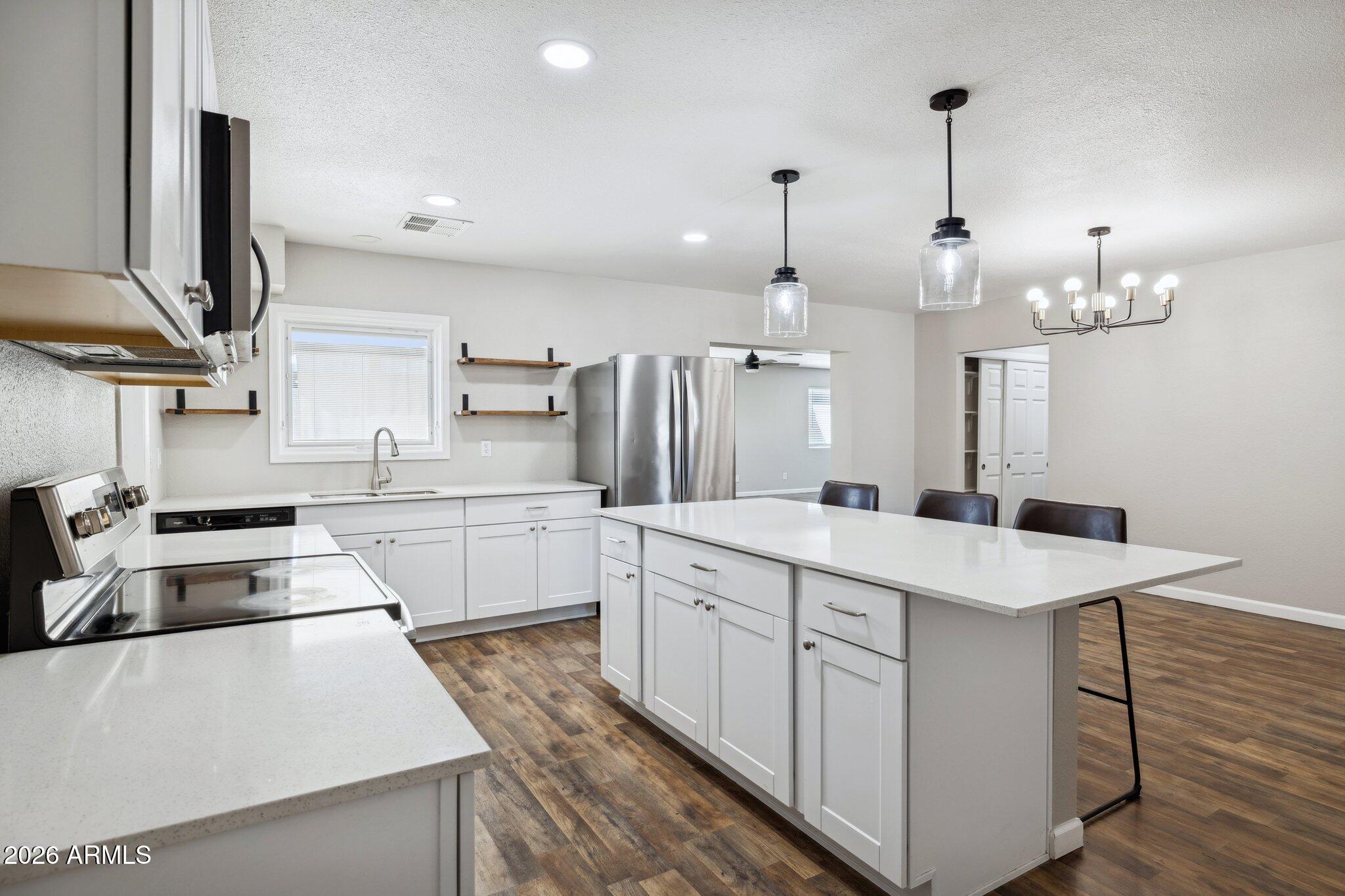 13002 North 28th Place Phoenix, AZ 85032 - Photo 7 of 42 a kitchen with white cabinets appliances and cabinets