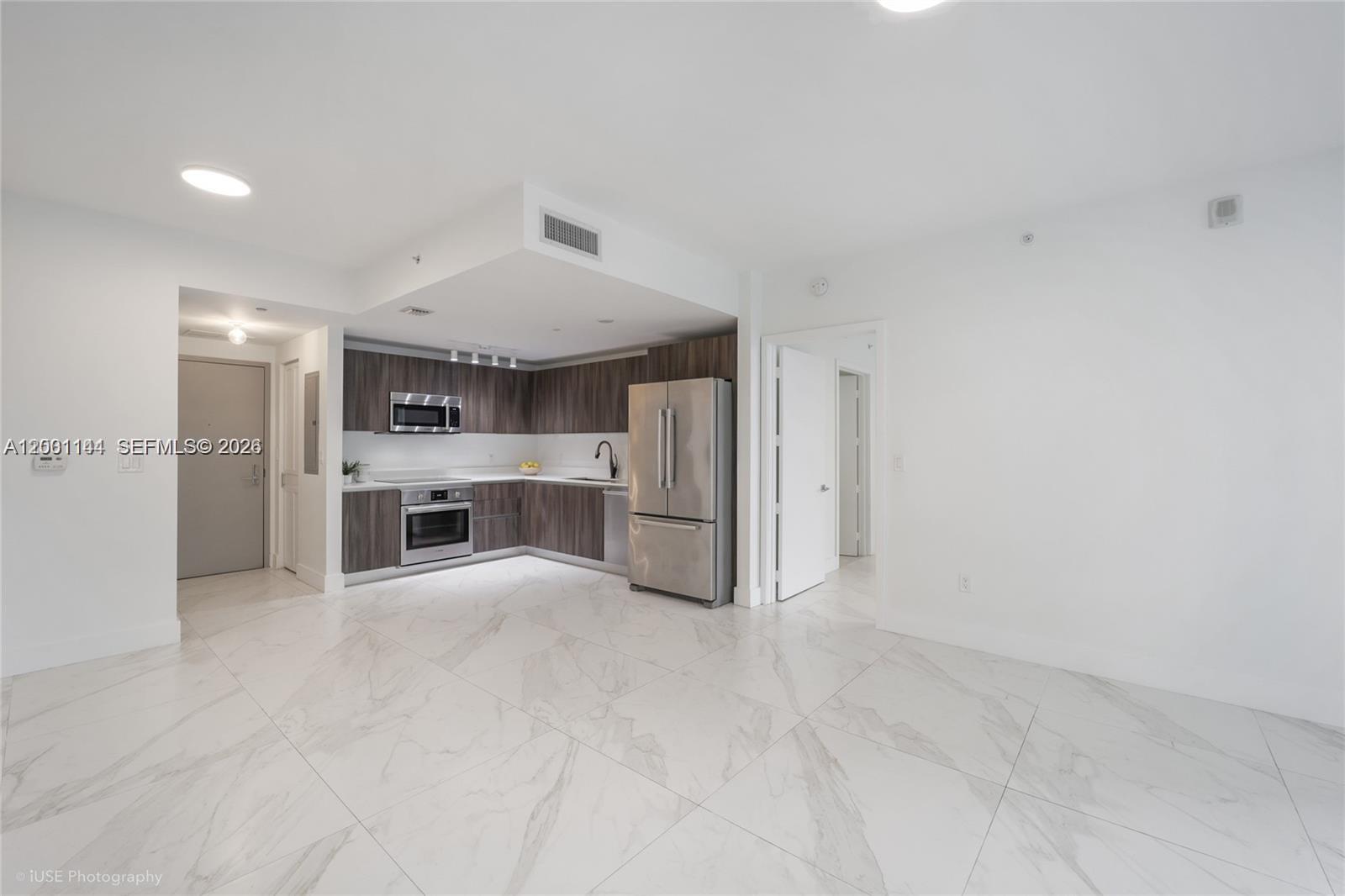 488 Northeast 18th Street, Unit 505 Miami, FL 33132 - Photo 3 of 12 a view of a kitchen with a sink and dishwasher cabinets