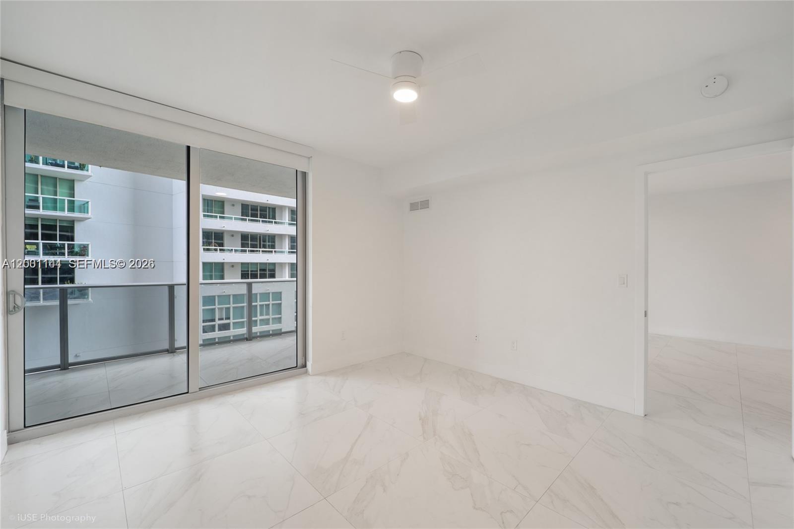 488 Northeast 18th Street, Unit 505 Miami, FL 33132 - Photo 6 of 12 an empty room with windows