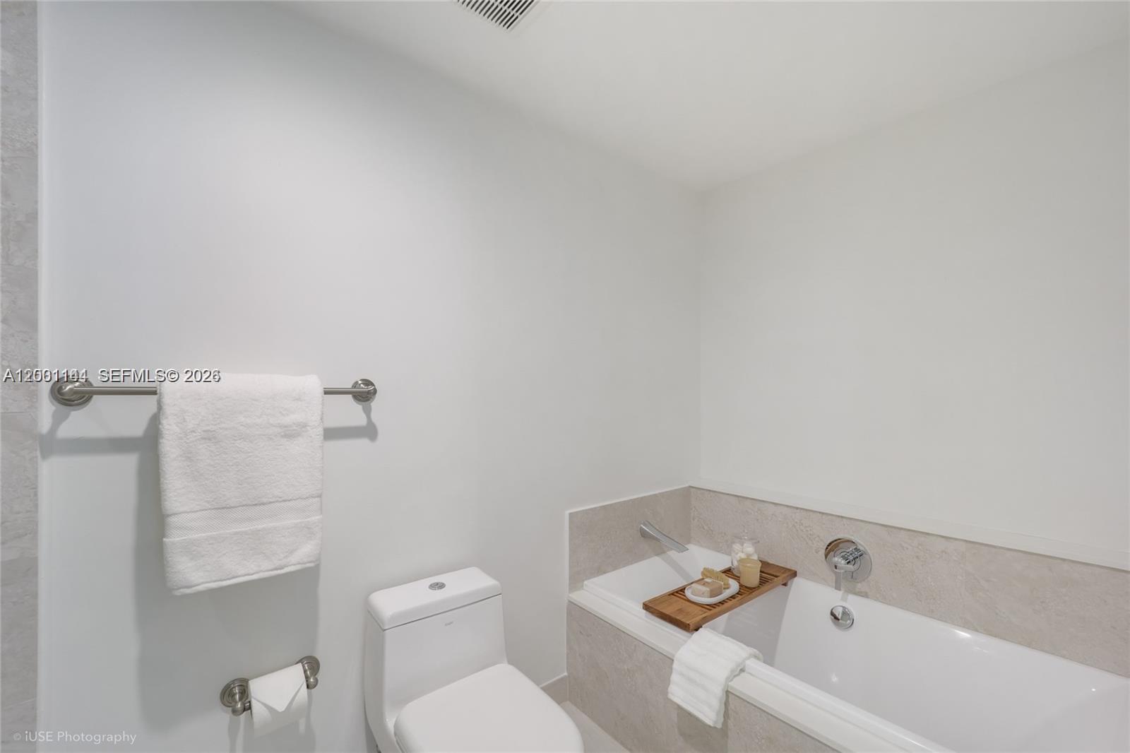 488 Northeast 18th Street, Unit 505 Miami, FL 33132 - Photo 9 of 12 a white toilet sitting next to a bath tub