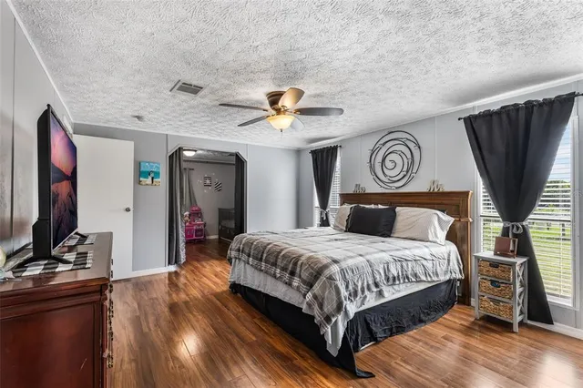 a bedroom with furniture and wooden floor
