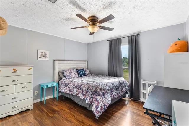 a bed room with a bed and a ceiling fan