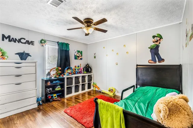 a bedroom with a bed and a baby bed