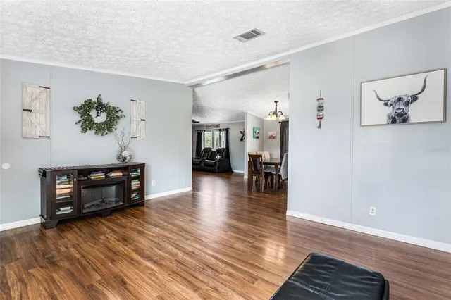 a view of a livingroom with furniture window and wooden floor