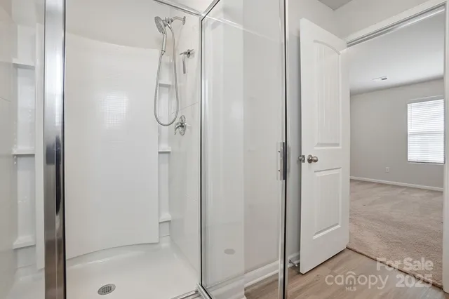 a bathroom with a glass shower door
