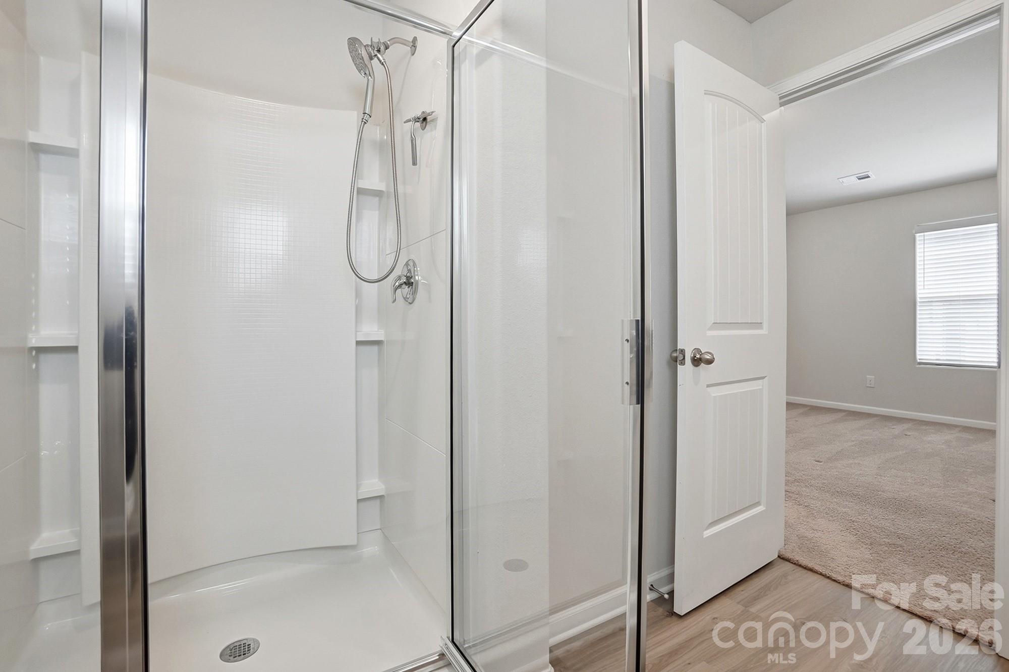 907 Morien Street Richburg, SC 29729 - Photo 20 of 28 a bathroom with a glass shower door