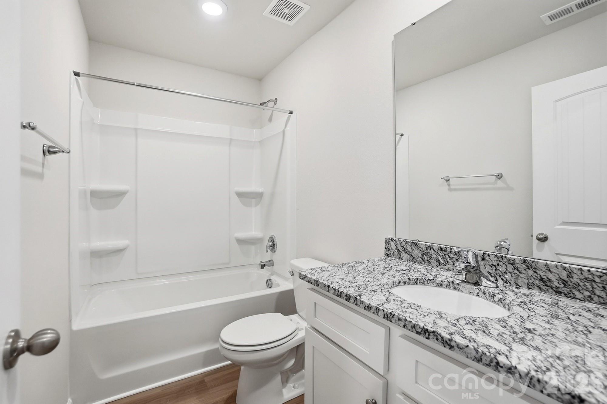 907 Morien Street Richburg, SC 29729 - Photo 24 of 28 a bathroom with a granite countertop sink toilet and shower