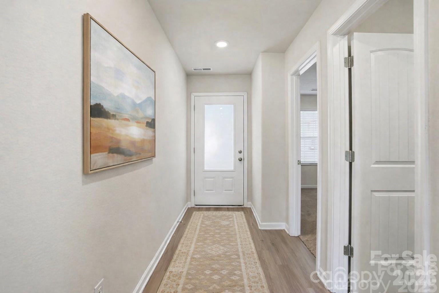 907 Morien Street Richburg, SC 29729 - Photo 3 of 28 a view of a hallway with wooden floor and a bathroom