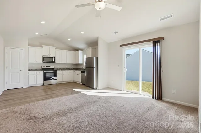 a view of a kitchen with a sink and stainless steel appliances