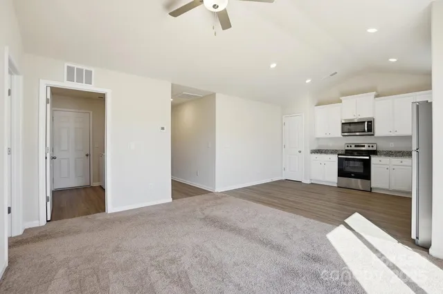 a view of kitchen with sink microwave and stove