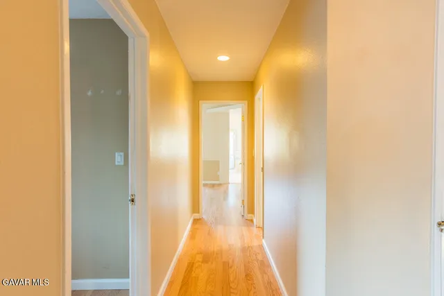 a view of a livingroom with wooden floor and a ceiling fan
