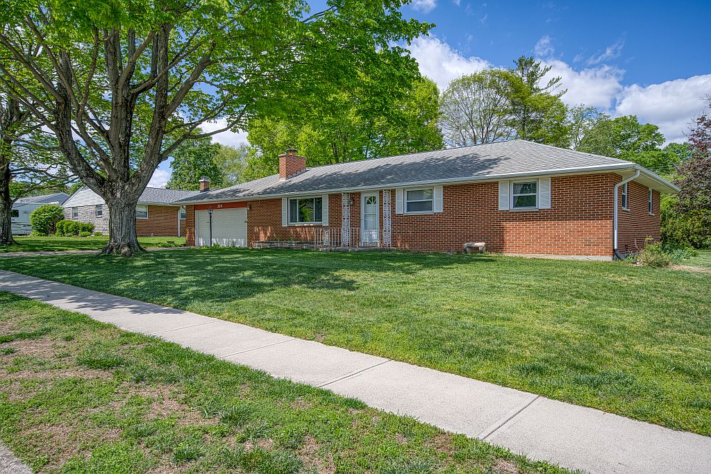 324 Beckenham Road Englewood, OH 45322 - Photo 2 of 26 This classic brick residence features a lush lawn and inviting front facade.