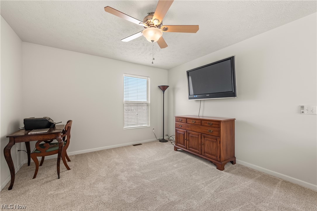 3967 Gardiner Run Akron, OH 44321 - Photo 17 of 35 Carpeted loft with a textured ceiling and ceiling fan