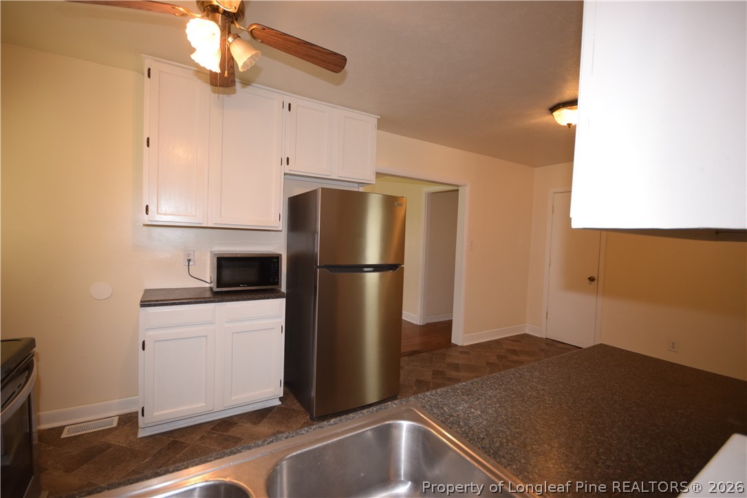 108 South 6th Street Spring Lake, NC 28390 - Photo 11 of 20 a kitchen with a refrigerator and a sink