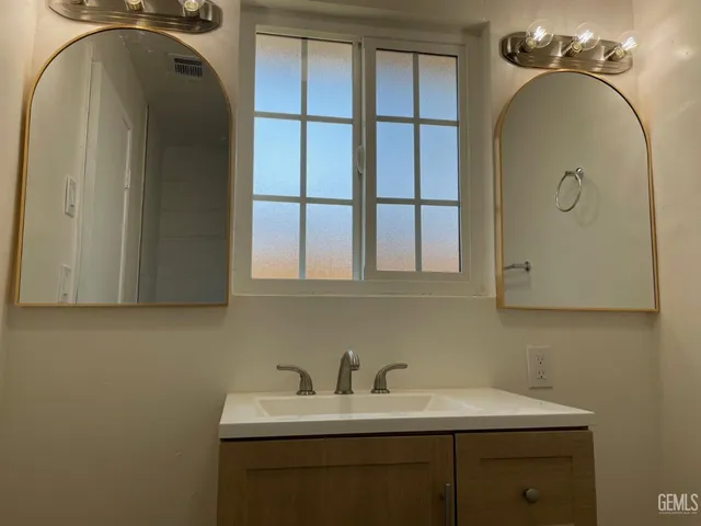 a bathroom with a sink and a mirror