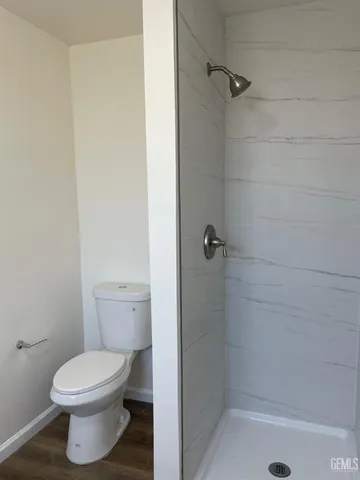 a bathroom with a toilet and a shower