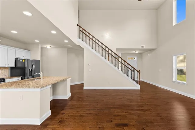 a view of kitchen with counter top space and wooden floor