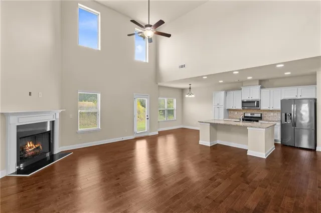 a kitchen with stainless steel appliances granite countertop a refrigerator stove microwave and sink