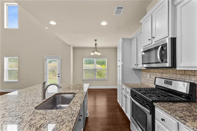 a view of a room with wooden floor closet and windows