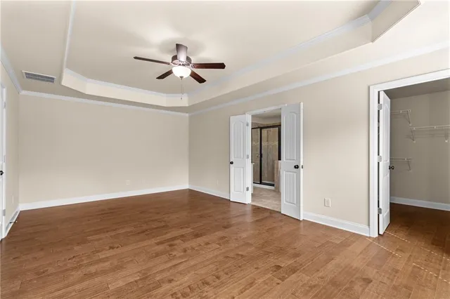 a spacious bathroom with a granite countertop sink a mirror a bathtub and next to a window