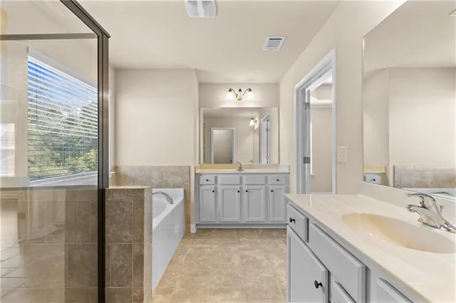 a bathroom with a bathtub and a shower