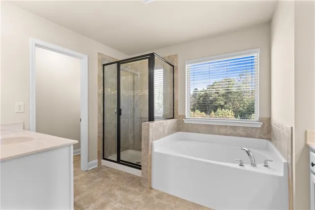 a bathroom with a bathtub and a sink