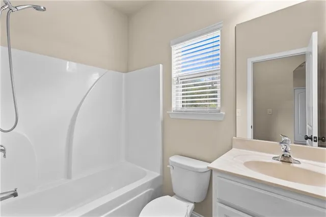 a bathroom with a granite countertop sink a shower and a mirror
