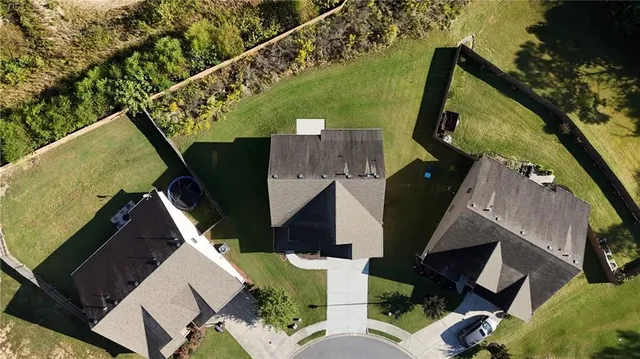 an aerial view of a house with a yard and potted plants