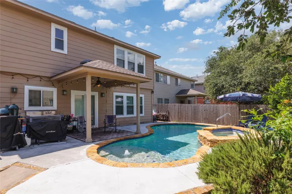 a view of a house with backyard sitting area and garden