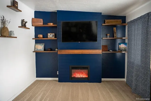 a living room with a fireplace and a flat screen tv