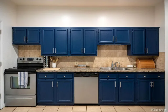 a kitchen with granite countertop wood cabinets and stainless steel appliances