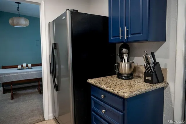 a kitchen with a refrigerator and a sink