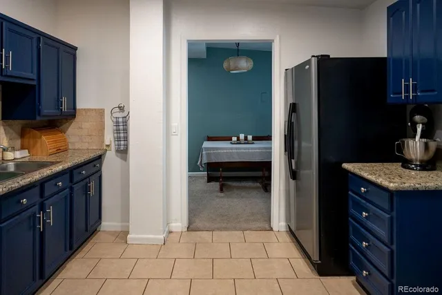 a kitchen with a refrigerator and cabinets