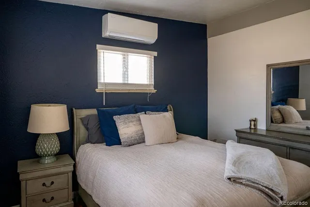 a bedroom with a bed and a lamp on table