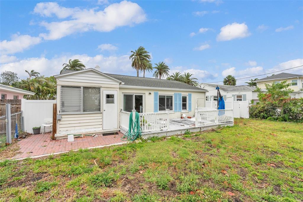 752 Lantana Avenue Clearwater Beach, FL 33767 - Photo 6 of 7 a front view of a house with a yard