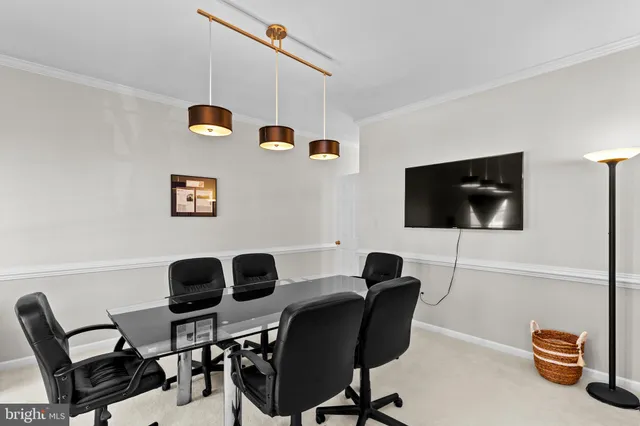 a work room with furniture and a flat screen tv