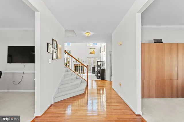 a view of a livingroom with wooden floor and stairs