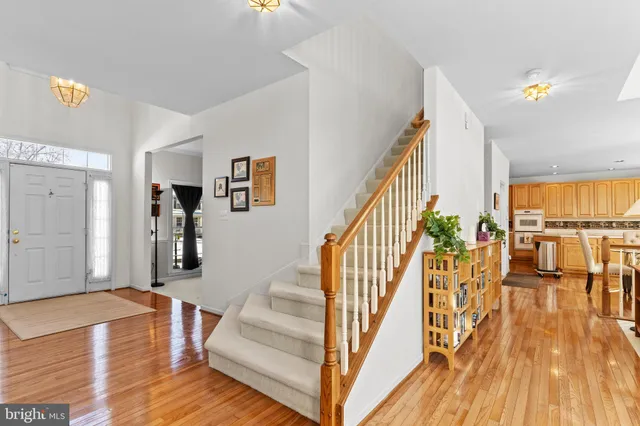 a view of entryway and hall with wooden floor