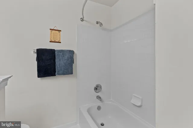 a bedroom with a bed a table and a large mirror