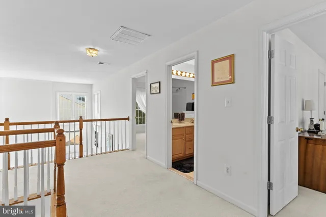 a view of a hallway with windows and stairs