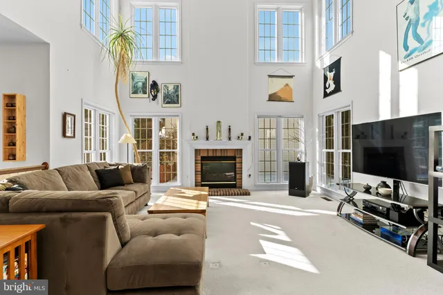 a living room with fireplace furniture and a flat screen tv