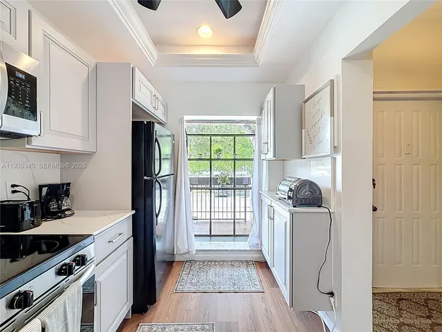 a kitchen with stainless steel appliances granite countertop a refrigerator and a stove top oven