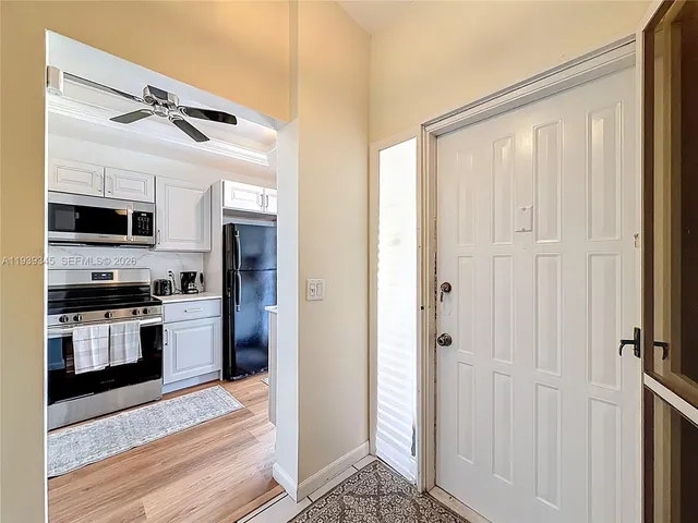 a kitchen with a sink cabinets and stainless steel appliances