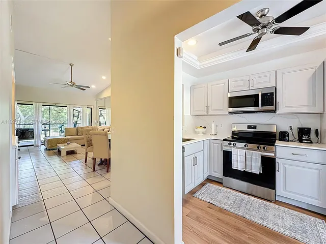 a kitchen with a sink stainless steel appliances and cabinets