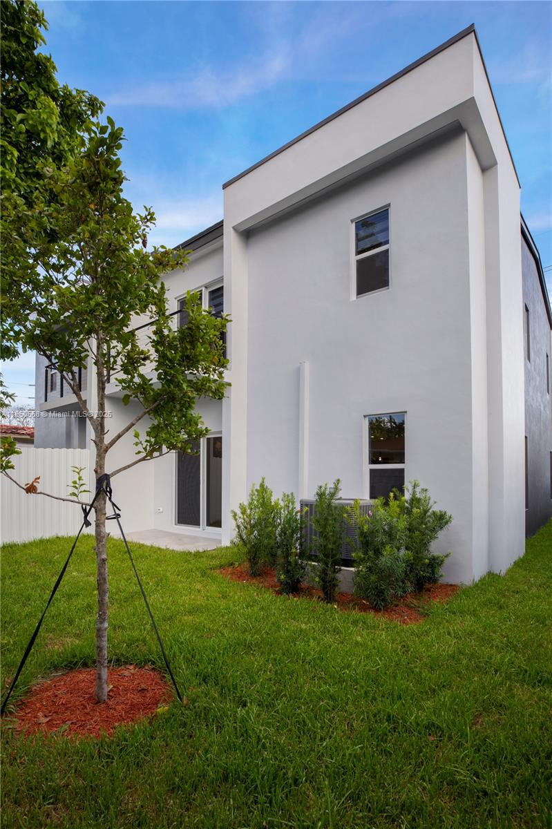3431 Southwest 16th Terrace, Unit 3431 Miami, FL 33145 - Photo 15 of 16 a backyard of a house with plants and wooden fence