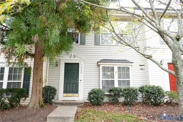 a house that has a tree in front of the house