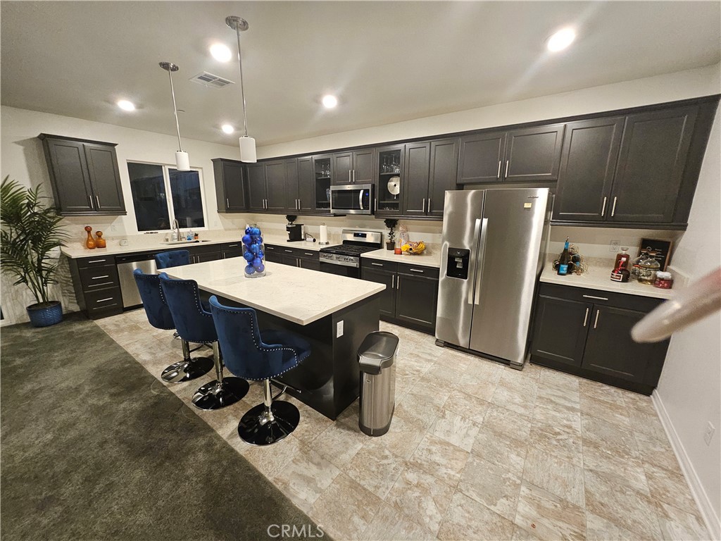 7900 Raincross Court Riverside, CA 92507 - Photo 3 of 21 a kitchen with refrigerator and chairs