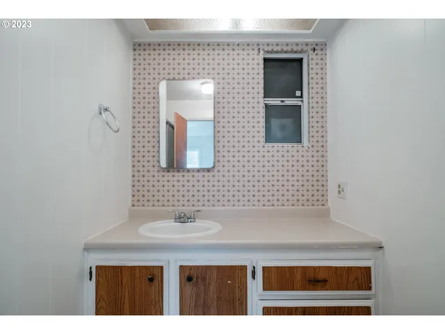 a bathroom with a sink a mirror and a vanity