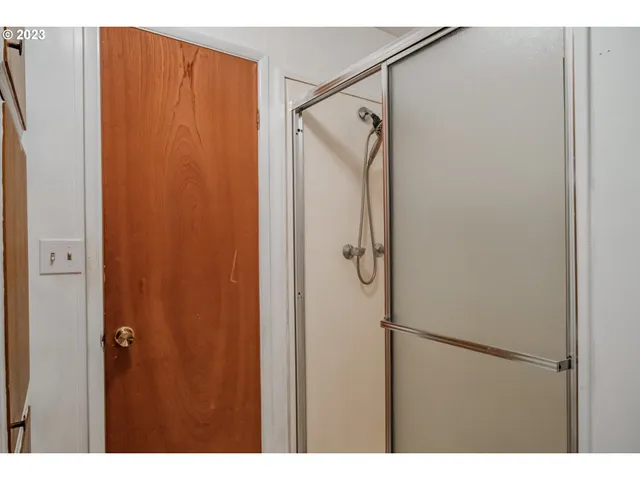 a bathroom with a shower and a glass door